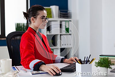 Entrepreneur in business corporate office workplace working on laptop Stock Photo