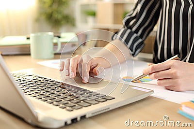 Entrepreneur hands comparing graph report on laptop Stock Photo