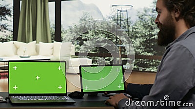 Entrepreneur works with greenscreen on laptop and tablet Stock Photo