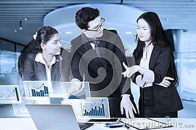 Entrepreneurs discussing financial statistics Stock Photo