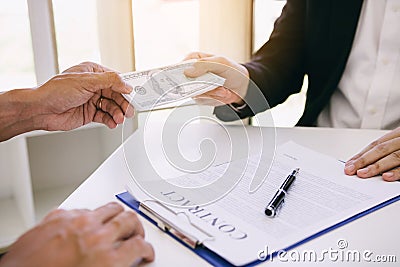 Entrepreneurs are receiving money that is a bribe of their partners with both of whom are corrupt in the company room Stock Photo