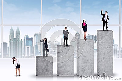 Entrepreneurs standing on the ranking bars Stock Photo