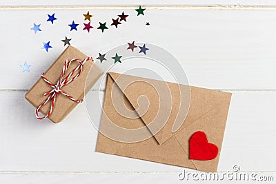 Envelope Mail with Red Heart and gift box over White Wooden Background. Valentine Day Card, Love or Wedding Greeting Concept Stock Photo