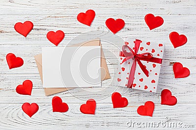 Envelope Mail with Red Heart and gift box over White Wooden Background. Valentine Day Card, Love or Wedding Greeting Concept Stock Photo