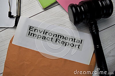 Environmental Impact Report text with document brown envelope and gavel isolated on office desk Stock Photo