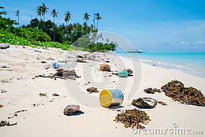 Environmental trash disgarded on idyllic beach Stock Photo