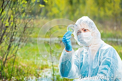 environmentalist in protective clothing examines infected plants Stock Photo