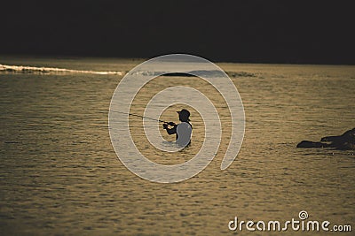 Enyoing recreational fishing on the beach Stock Photo