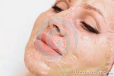Enzyme mask in the process of drying on a woman`s face close-up. Rejuvenation and facelift in cosmetology Stock Photo