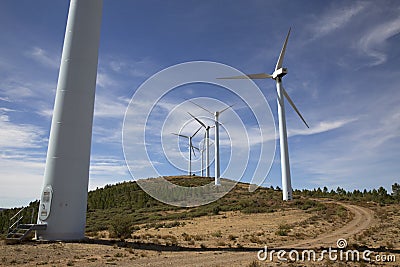 Eolic wind Turbines on a modern windmill farm for alternative energy generation Stock Photo