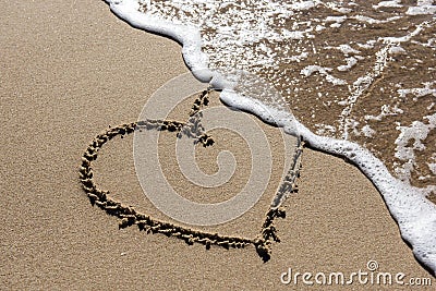 Heart in the sand, ephemeral love Stock Photo