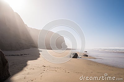 Epic Misty Beach with Cliffs Stock Photo