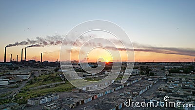 An epic sunset with a view of the smoking factory Editorial Stock Photo