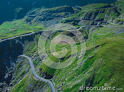 Epic winding road on Transfagarasan pass in Romania in summer time, with twisty road rising up. Road crossing Fagaras mountain Stock Photo