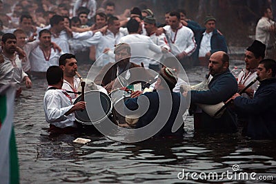 Epiphany Traditions - Jordan. Men dance in the icy waters of the river Tunja on January 6, 2011, Kalofer, Bulgaria Editorial Stock Photo