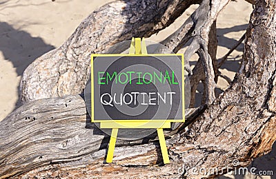 EQ emotional quotient symbol. Concept words EQ emotional quotient on beautiful black yellow house blackboard. Beautiful tree Stock Photo