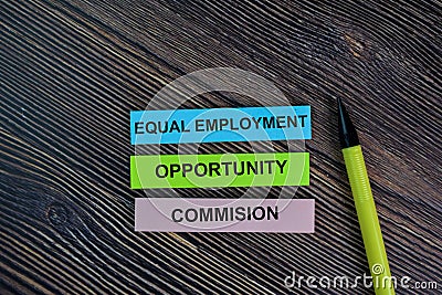 Equal Employment Opportunity Commision write on sticky notes isolated on Wooden Table Stock Photo