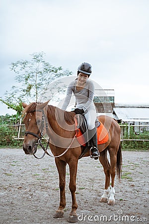 Equestrian athletes ride horses and stroke horses after competing Stock Photo