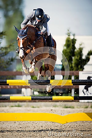 Equestrian Horse Rider Jumping.Picture showing a competitor performing in show jumping competition Editorial Stock Photo