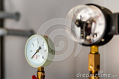 The equipment of the boiler-house, - valves, tubes, pressure gauges, thermometer. Close up of manometer, pipe, flow meter, water Stock Photo