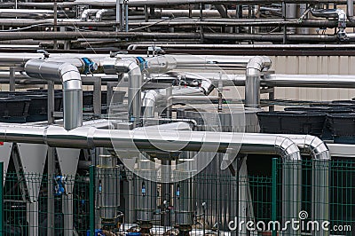 Equipment, cables and pipelines outside a modern cheese factory in France, close-up Stock Photo