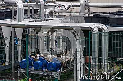 Equipment, cables and pipelines outside a modern cheese factory in France, close-up Stock Photo