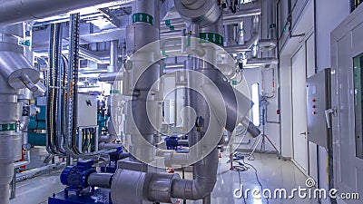 Equipment, cables and piping as found inside of industrial chiller plant room timelapse Stock Photo