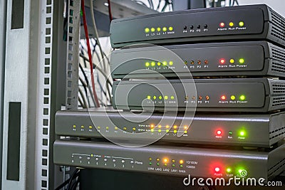 Equipment for Internet connection works in computer racks. Several digital communication gateways are in the server room. Stock Photo