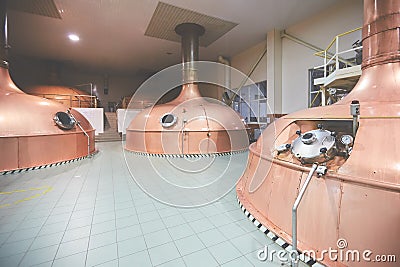 Equipment for preparation of beer. Lines of cooper tanks in brewery. Manufacturable process of brewage. Mode of beer Stock Photo