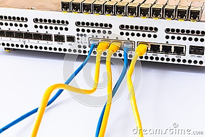 The equipment of radio base station, SFP modules, blue and yellow patch cords. Internet. Communication. Network Stock Photo