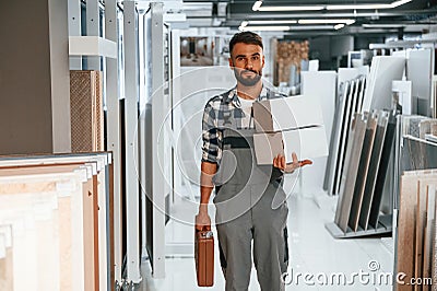 With equipment. Stylish beautiul man is in the store of goods for the home Stock Photo