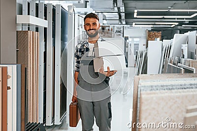 With equipment. Stylish beautiul man is in the store of goods for the home Stock Photo