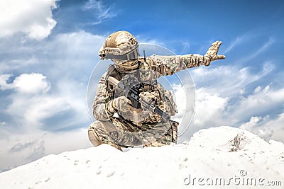 Equipped airsoft player showing halt hand signal Stock Photo