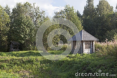 Equipped source and gazebo beside the road to the village Gorodischna, Nyuksensky District, Vologda Region Stock Photo