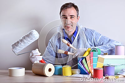 Equipped worker presenting paint products Stock Photo