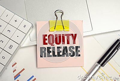 Equity Release symbol. pink paper sheet and pen, calculator and charts Stock Photo