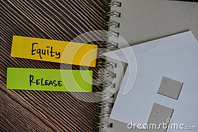 Equity Release write on sticky notes isolated on Wooden Table Stock Photo