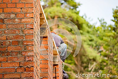 Erection of a red brick building wall Stock Photo