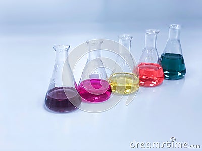 The Erlenmeyer or Conical flask on bench laboratory, with colorful solvent solution from titration experiment, acidity, alkalinity Stock Photo