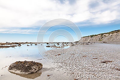 Eroded Cliffs and Sandy Beach Stock Photo