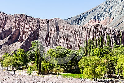 Eroded mountains in the Argentine Andes and green vegetation Stock Photo