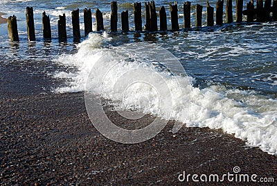 Eroded poles in the sea Stock Photo