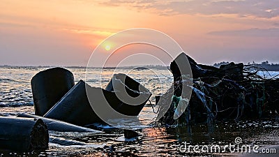 Erosion, wave destroy seawall, effect of climate change Stock Photo