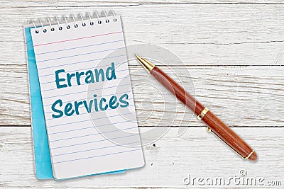 Errand Services message on retro lined paper notepad on a weathered wood desk Stock Photo