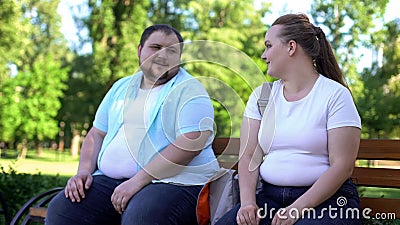 Erudite obese man telling interesting stories to pretty girl, self-confidence Stock Photo