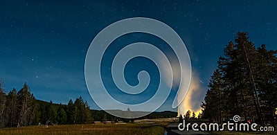 Eruption of Old Faithful geyser at Yellowstone National Park at night Stock Photo