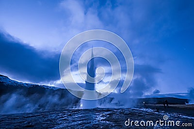 Eruption of Strokkur geyser in Iceland. Winter cold colors, moon lighting through night Stock Photo