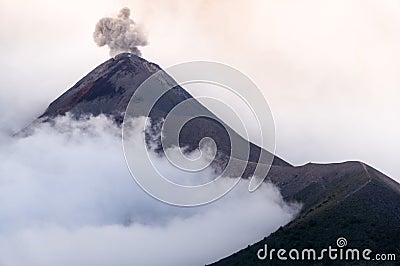 Eruption of volcano Fuego in cloudy and misty weather Stock Photo