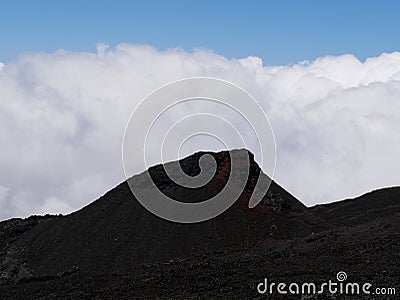 Eruptive cone of Fournaise volcano on top of the clouds, Reunion, France Stock Photo