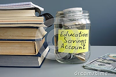 ESA Education Saving Account label on jar with money and books Stock Photo